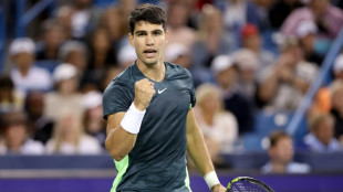 Alcaraz battles through rain, holder Garcia out