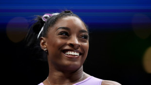 Biles leads US gymnastics championships at halfway stage