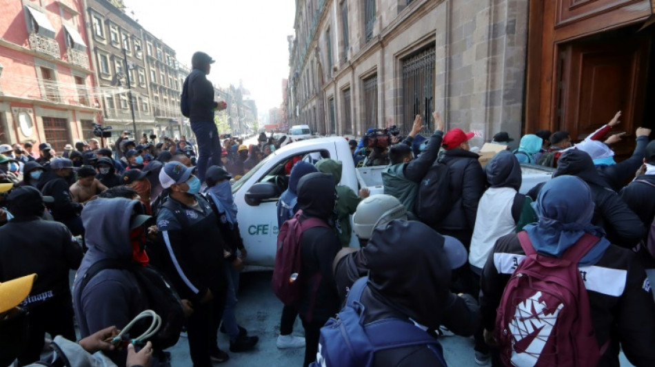 Manifestantes de Ayotzinapa derriban con un veh&iacute;culo la puerta del palacio presidencial en M&eacute;xico
