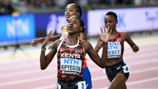 Kipyegon wins world 5,000m for historic double