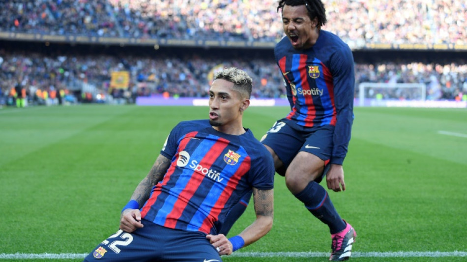 Raphinha header helps 10-man Barca to nervy Valencia win