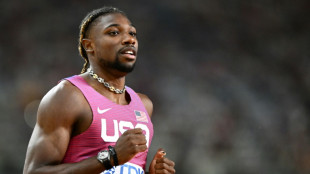 Lyles into final of world 200m despite golf buggy collision