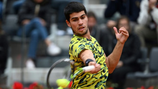 Alcaraz marks world number one spot with victory in soaking Rome