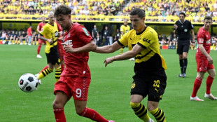 Malen strikes late to hand Dortmund victory over Cologne